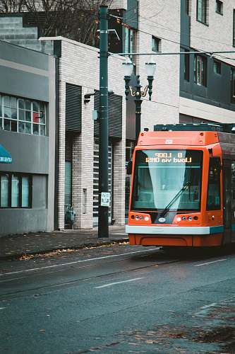 transportation orange and black vehicle on road at daytime vehicle